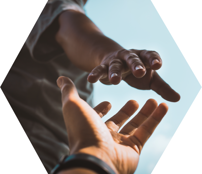 two hands reaching for one another against blue sky